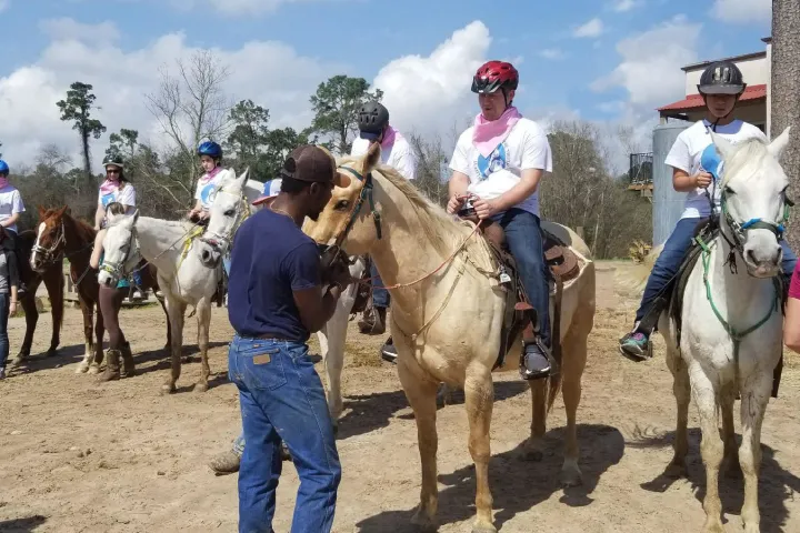 a group of people riding on the back of a horse