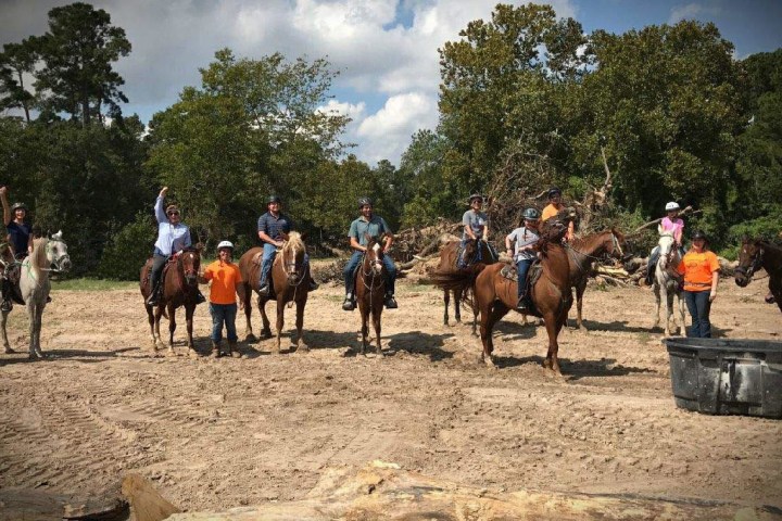 a group of people riding on the back of a horse