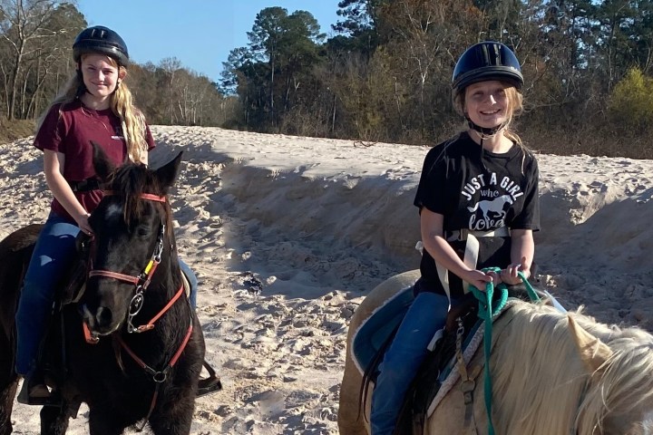a man and a woman riding a horse