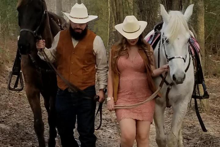 a group of people standing next to a horse