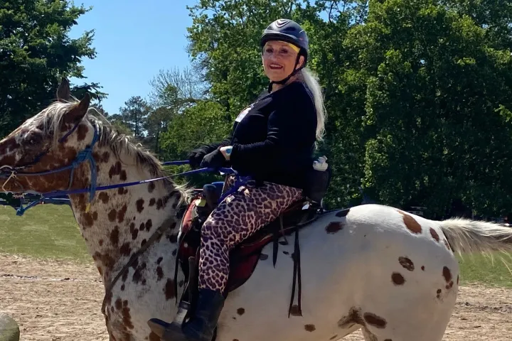a person riding on the back of a giraffe