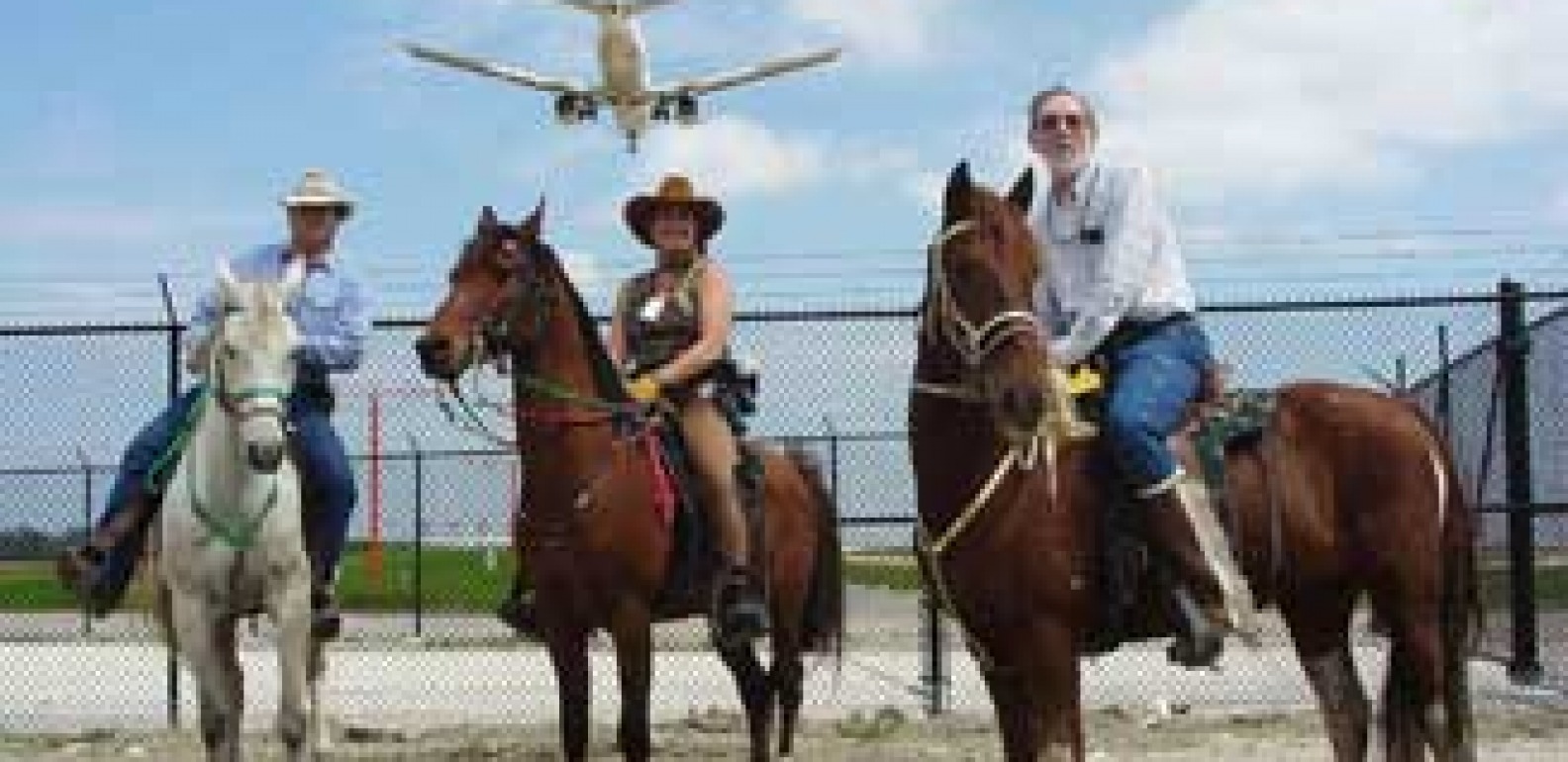 airport-m833a7y2rphcjsfxi9pm91o1zhfqrk5ly6twhm5pg4 a group of people riding on the back of a horse