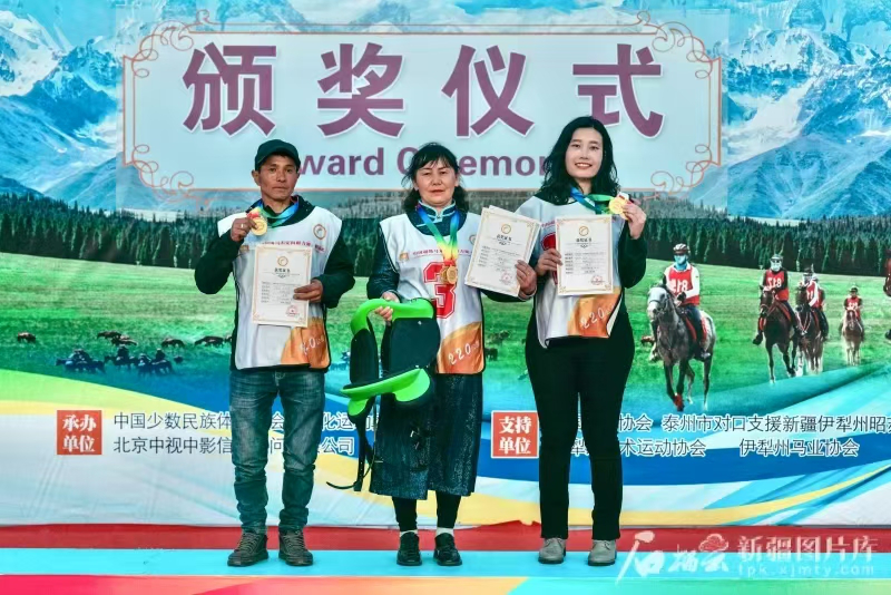 a group of people holding a sign posing for the camera