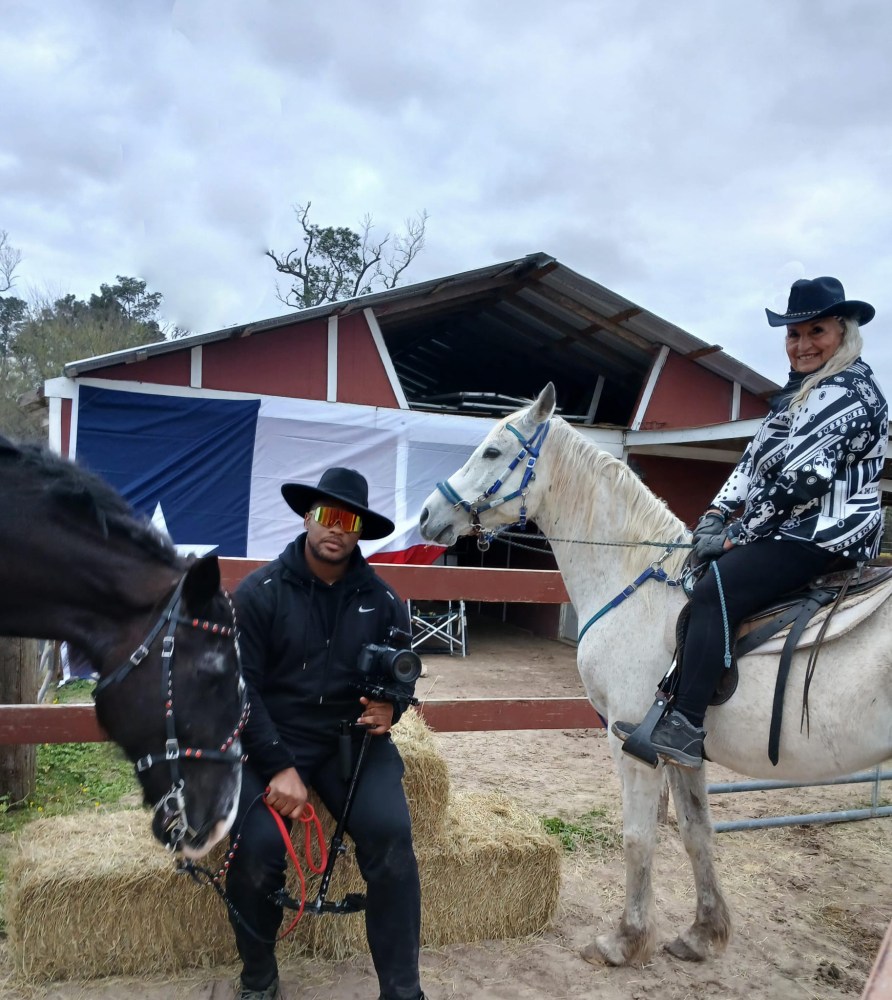 a man standing next to a horse